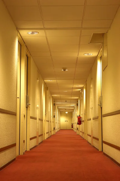 Červený koberec hotelové chodby — Stock fotografie