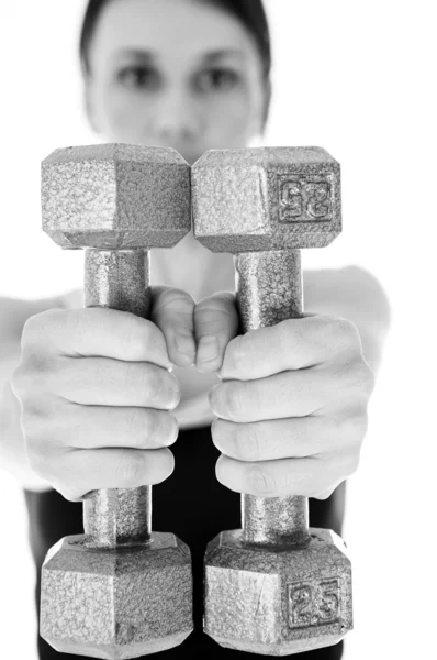 Sexy young adult Caucasian woman in a black training wear with small weights — Stock Photo, Image