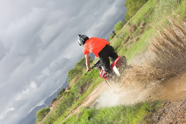 Giovane uomo in giro sul suo Dirtbike facendo trucchi e sporcarsi — Foto Stock