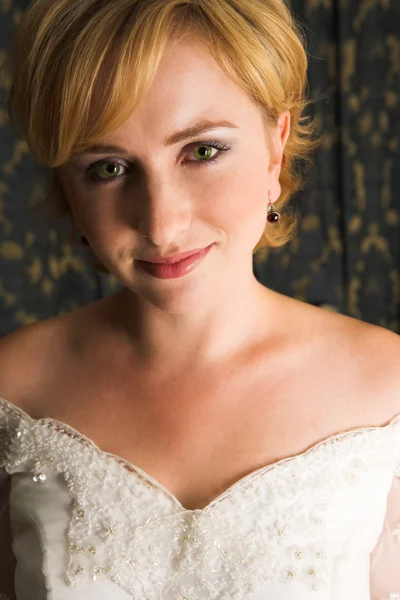 Young blonde bride with champagne colored wedding gown and red lips. — Stock Photo, Image