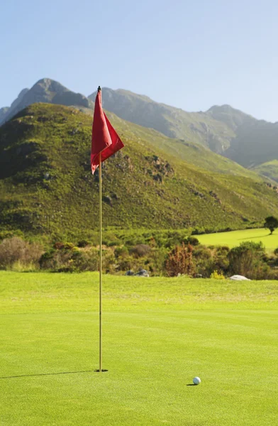 Golf course with a red flag. — Stock Photo, Image