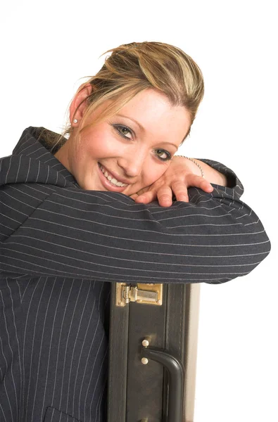 Business woman leaning on suitcase — Stock Photo, Image