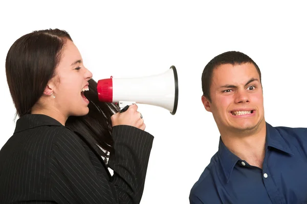A brunette woman yelling at her male business partner over a microphone. Stock Picture