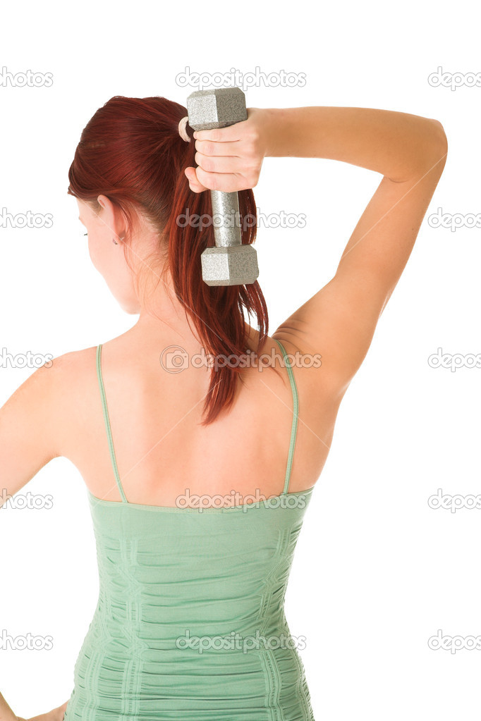 Woman standing with weight behind her back, white background.