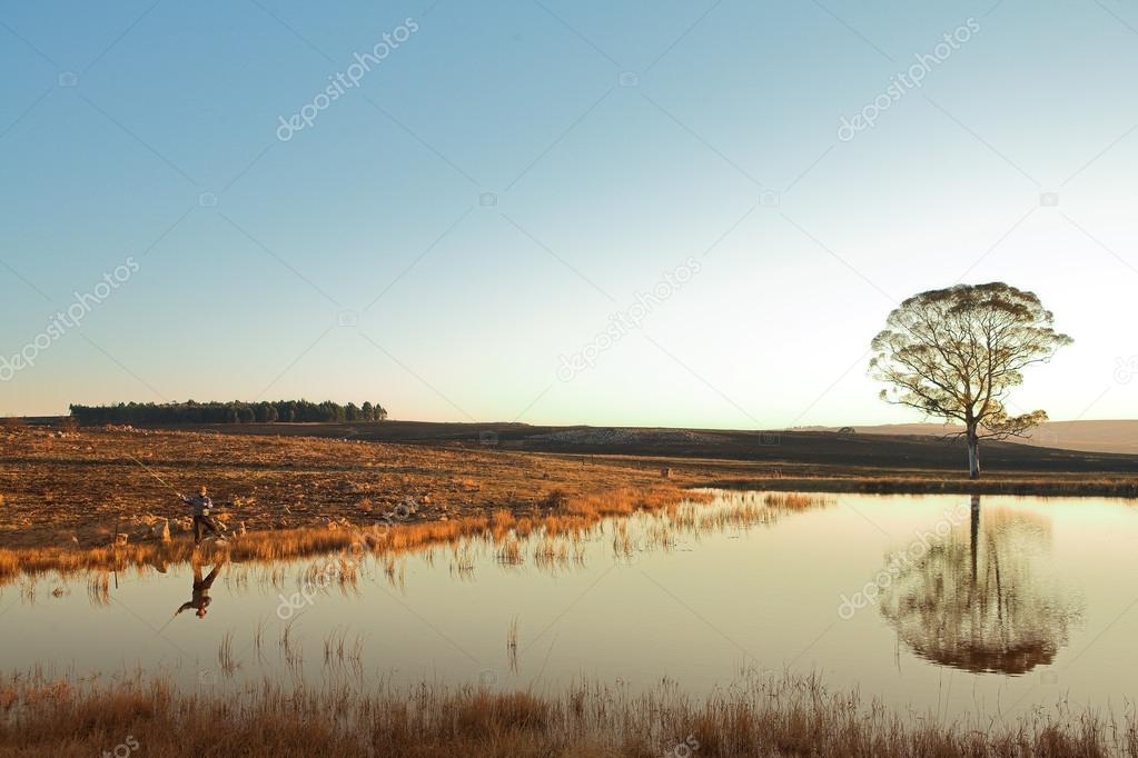 A fly fisherman casting a line in Dullstroom
