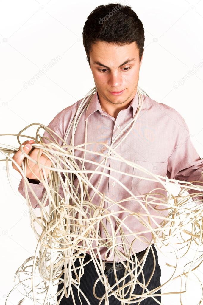 Businessman tangled up in power cables