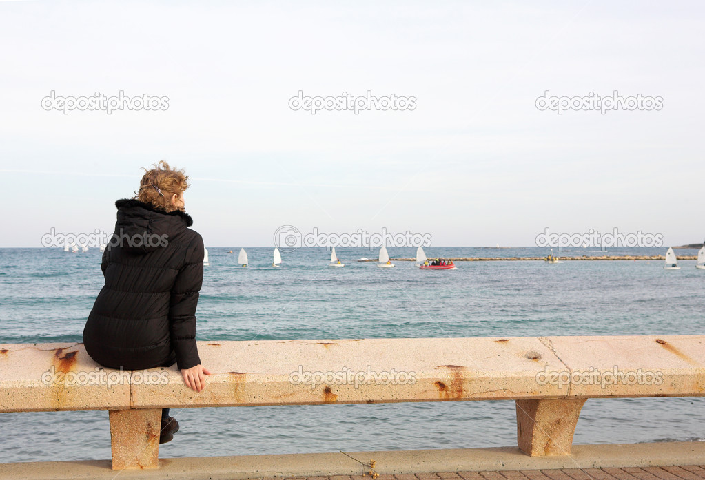 A person sitting on a pier in Antibes