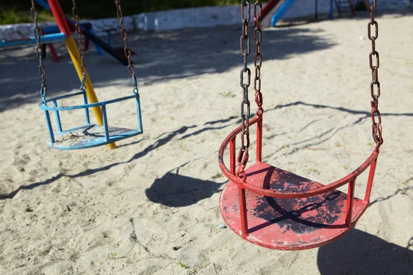 Empty old swings on a playground for children — Stock Photo, Image