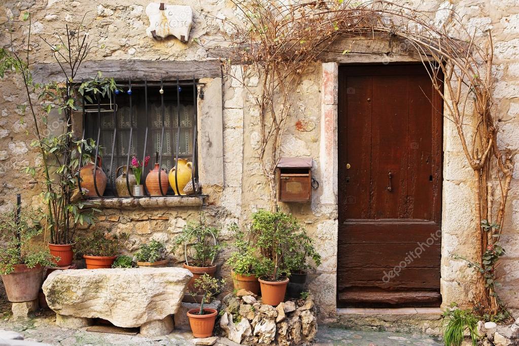 Street Garden With Street Name And Potted Plants In Front Of