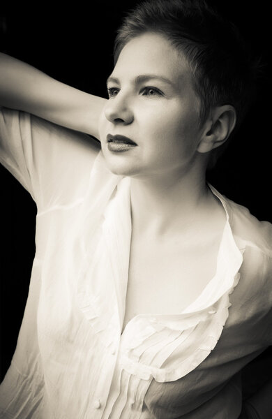 Beautiful young adult woman with short hair in a classic and iconic, stylized black and white portrait
