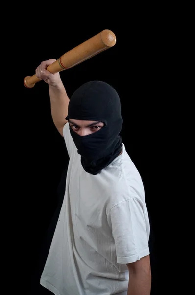 Masked man aims and attack with bat — Stock Photo, Image