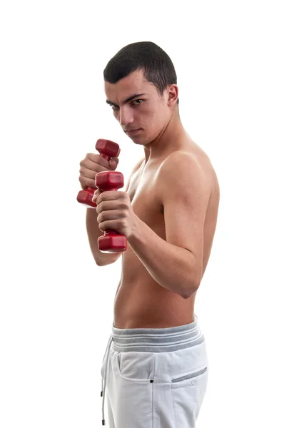 Fit young man exercising with red dumbbell — Stock Photo, Image