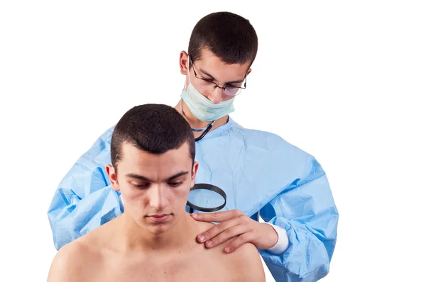 Dermatologist examines a mole of male patient — Stock Photo, Image