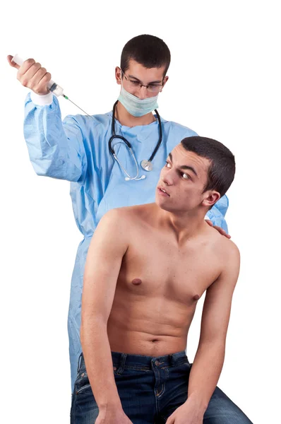 Doctor with a syringe ready to give an injection to a scared patient — Stock Photo, Image