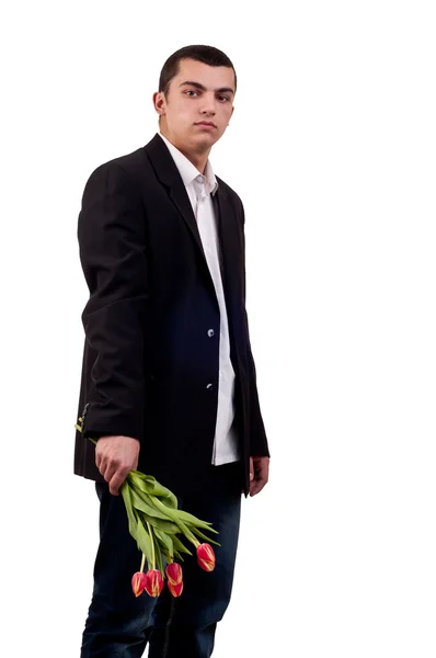 Молодий чоловік з квітами тюльпанів — стокове фото
