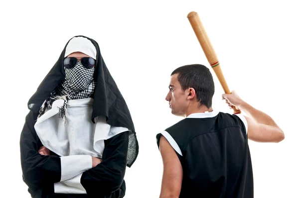 A young male actor in a nun outfit attacked by a hooligan with baseball bat — Stock Photo, Image