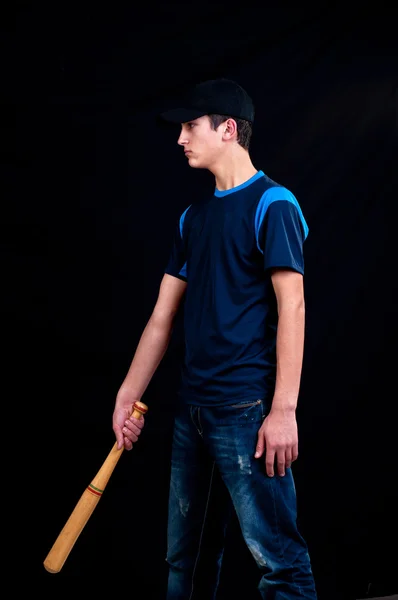 Young man playing baseball for fun on black background — Stock Photo, Image