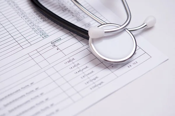 Closeup of a black stethoscope on a medical analysis — Stock Photo, Image