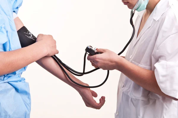 Doctor is measuring blood pressure with a tonometer — Stock Photo, Image