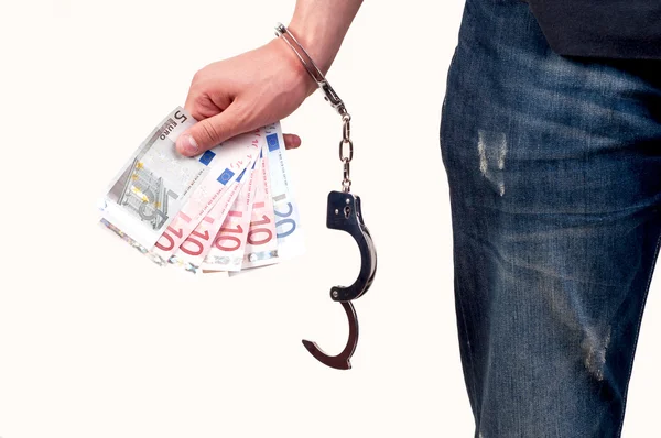 Hand with handcuffs holding money on white background — Stock Photo, Image
