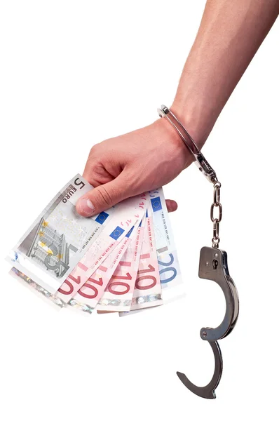 Hand with handcuffs holding money on white background — Stock Photo, Image