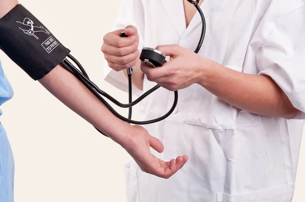 Doctor measuring blood pressure Stock Photo