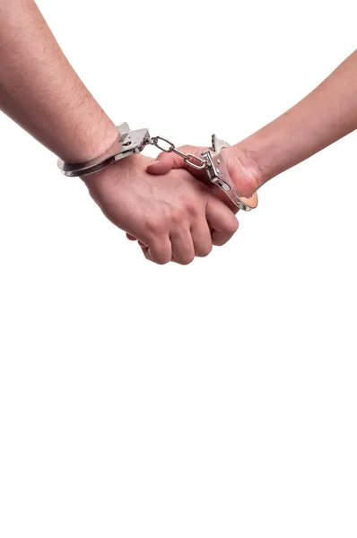 Man and woman holding hands in handcuffs - relationship concept — Stock Photo, Image