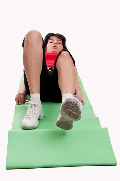 Young woman doing exercise for abs isolated on white background — Stock Photo, Image