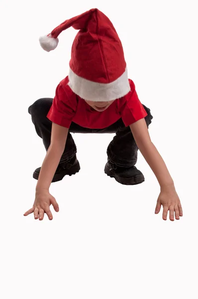 Gelukkig jongetje in hoed van santa claus genieten van dat Kerstmis ik — Stockfoto