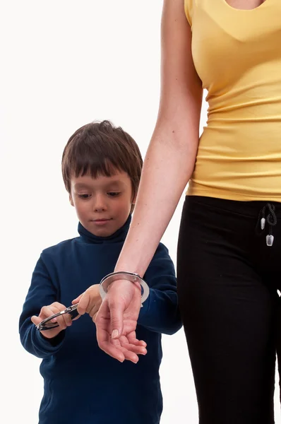 Mother and son playing cops and robbers, chained with the handcu — Stock Photo, Image