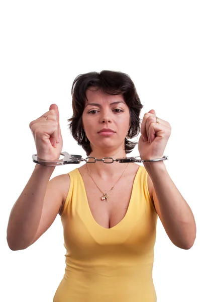 Young beautiful woman in handcuffs isolated on white — Stock Photo, Image