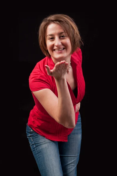 Beautiful and attractive young woman blowing a kiss to you — Stock Photo, Image