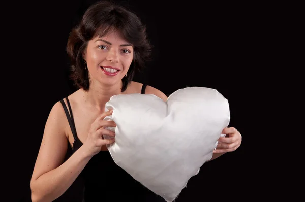 A beautiful young woman with a white heart in hand — Stock Photo, Image