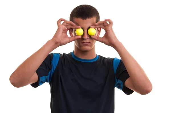 Young smiling male golf player covering his eyes with two yellow — Stock Photo, Image
