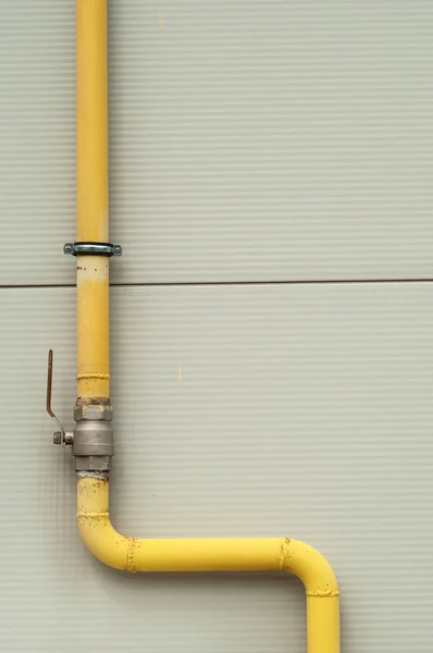 Yellow gas pipe with a crane and valve — Stock Photo, Image