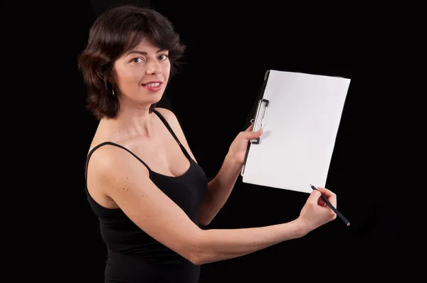 Studio shot of young woman writing notes on clipboard and showin — Stock Photo, Image