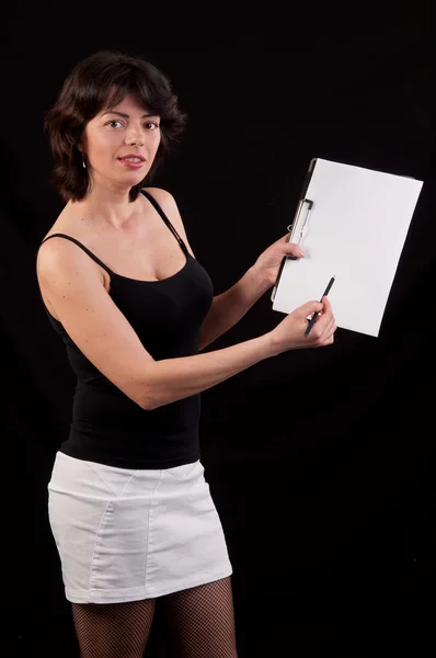 Studio shot of young woman writing notes on clipboard and showin — Stock Photo, Image