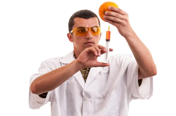 Scientist injecting GMO into orange, genetic modification of fre — Stock Photo, Image