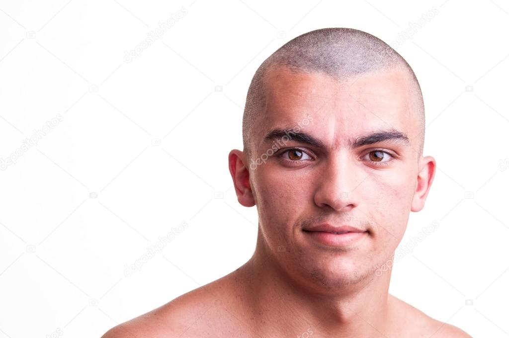Close up studio shot of bald young man over white background