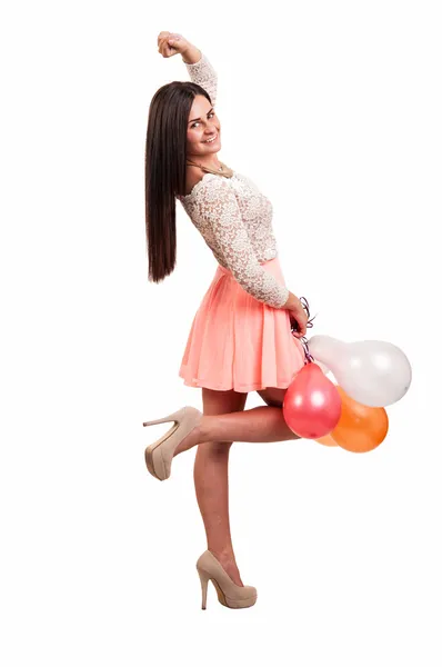 Young happy girl holding a bunch of colored balloons on white ba — Stock Photo, Image