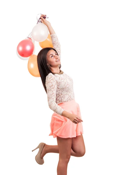 Jovem menina feliz com um monte de balões coloridos — Fotografia de Stock