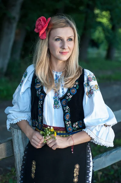 Beautiful singer with flowers posing in traditional costume, rom — Stock Photo, Image