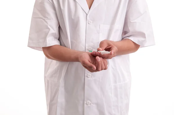 Closeup of young doctor injecting medicine in his hand — Stock Photo, Image