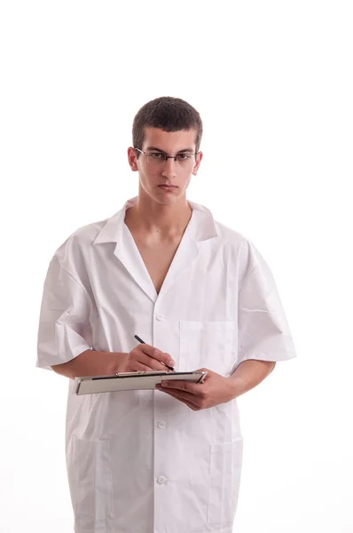 Seriously doctor writing on clipboard, he look to you — Stock Photo, Image