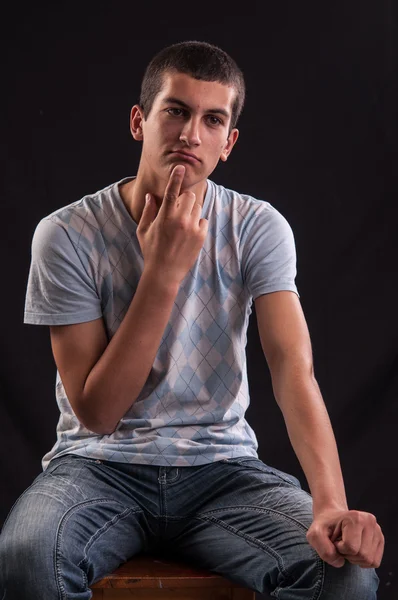 Teenage boy sits down and thinking about something — Stock Photo, Image