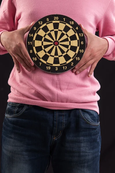Teenager holding a dartboard with his hands — Stock Photo, Image
