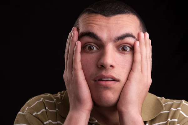 A shocked and surprised young man looking at the camera — Stock Photo, Image