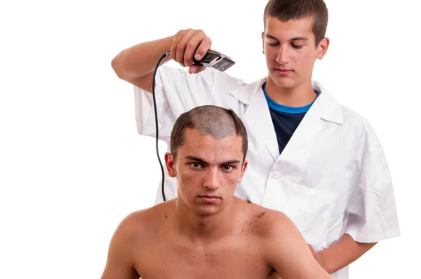 Homem com um corte de cabelo com um cortador de cabelo sobre um backgroun branco — Fotografia de Stock