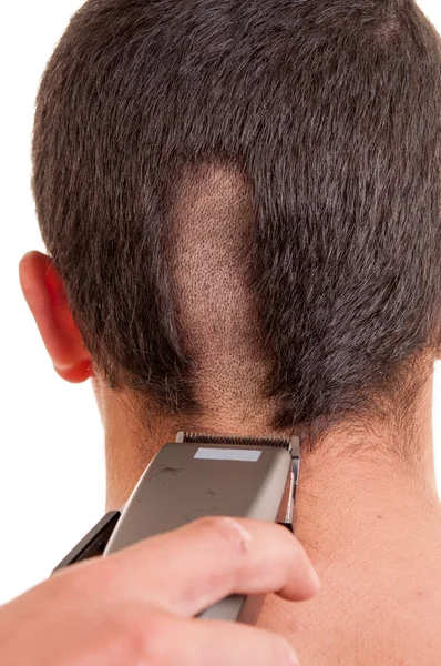 Uomo che ha un taglio di capelli con un tagliacapelli su un backgroun bianco — Foto Stock