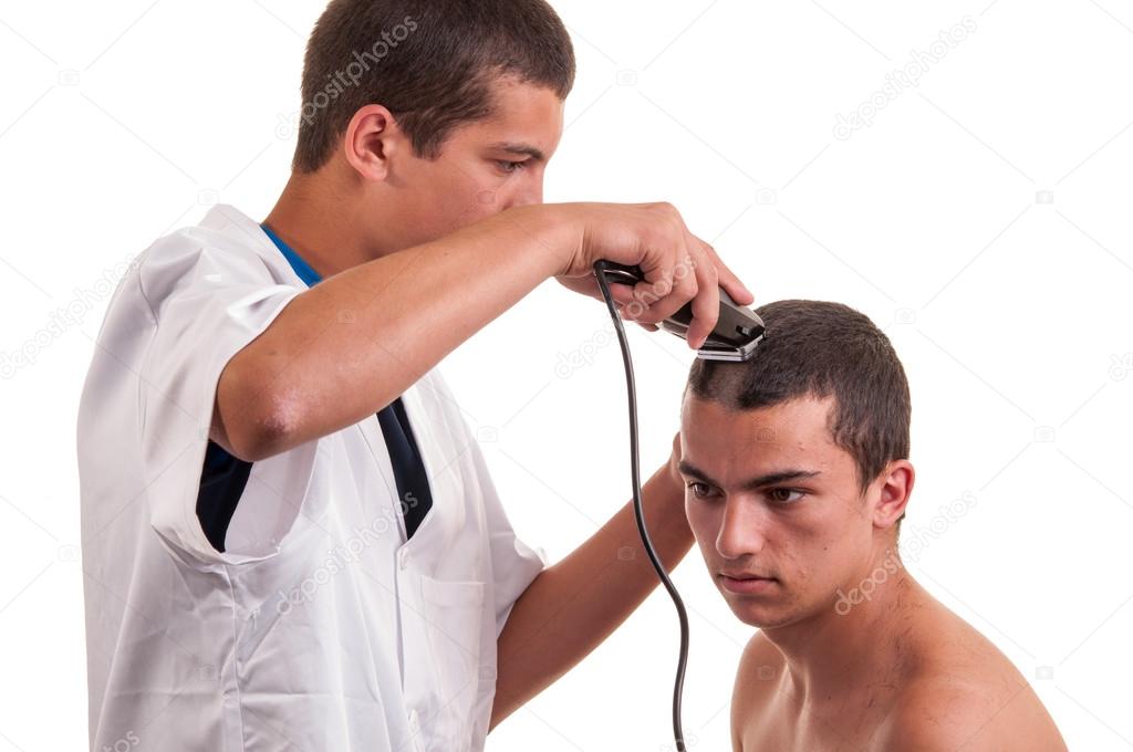 Man having a haircut with a hair clippers over a white backgroun